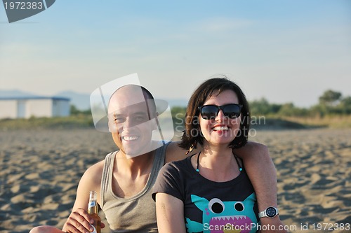 Image of happy young couple have fun on beach