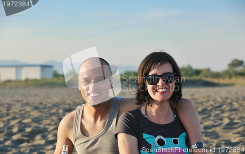 Image of happy young couple have fun on beach