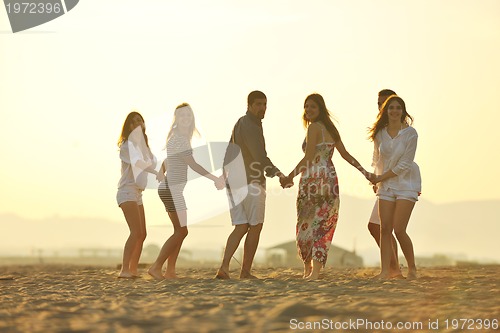 Image of happy young  people group have fun on beach