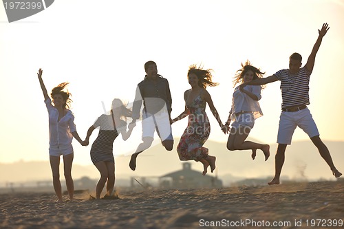 Image of Group of happy young people in have fun at beach