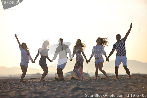 Image of happy young  people group have fun on beach