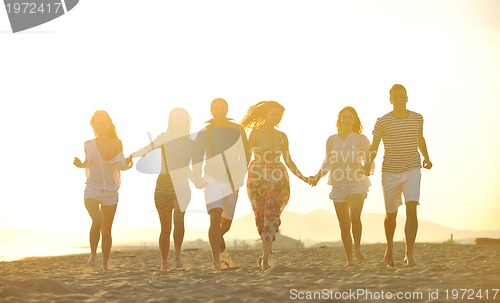 Image of happy young  people group have fun on beach