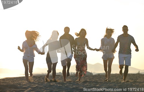 Image of happy young  people group have fun on beach