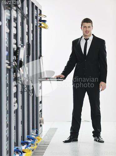 Image of young it engeneer in datacenter server room