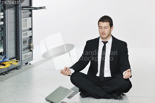 Image of business man practice yoga at network server room
