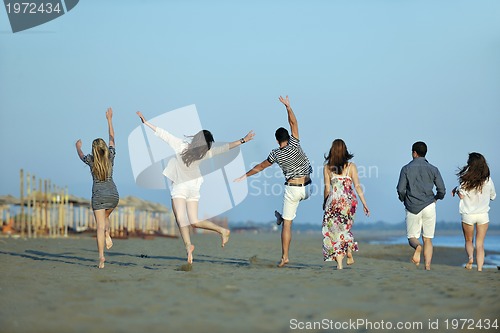 Image of happy young  people group have fun on beach