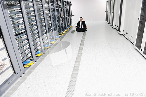 Image of business man practice yoga at network server room