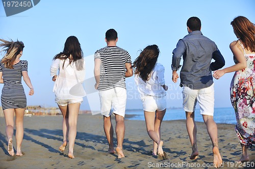 Image of happy young  people group have fun on beach