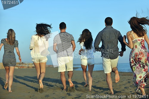 Image of happy young  people group have fun on beach