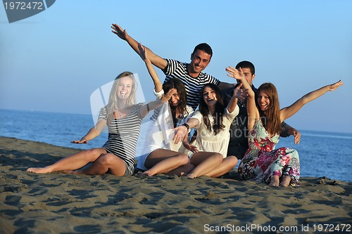 Image of happy young  people group have fun on beach