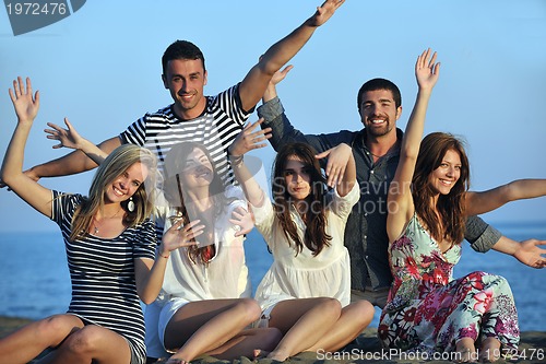 Image of happy young  people group have fun on beach