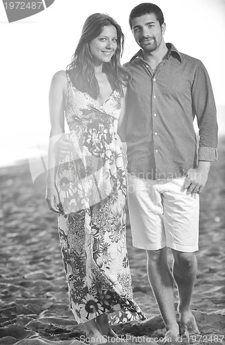 Image of happy young couple have romantic time on beach