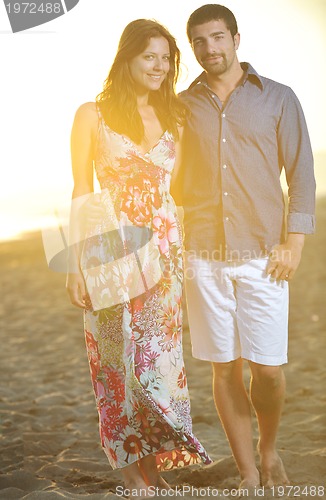 Image of happy young couple have romantic time on beach