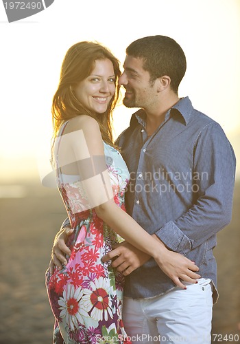 Image of happy young couple have romantic time on beach