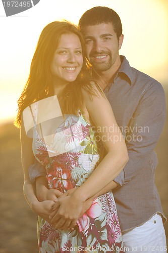 Image of happy young couple have romantic time on beach