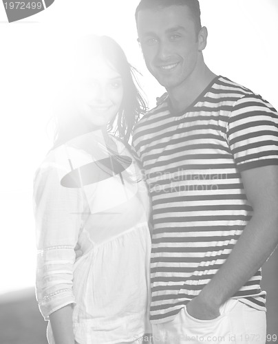 Image of happy young couple have romantic time on beach