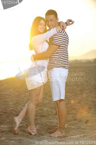 Image of happy young couple have romantic time on beach