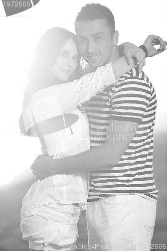 Image of happy young couple have romantic time on beach