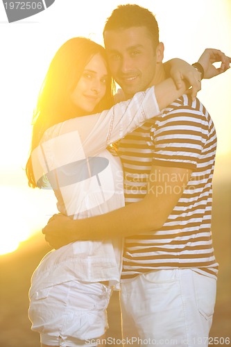 Image of happy young couple have romantic time on beach