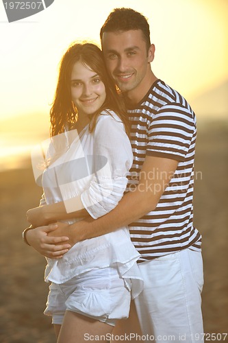 Image of happy young couple have romantic time on beach