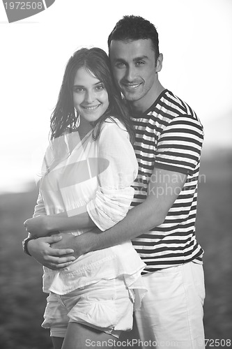 Image of happy young couple have romantic time on beach