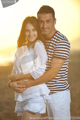Image of happy young couple have romantic time on beach