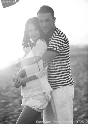 Image of happy young couple have romantic time on beach