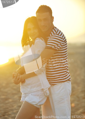 Image of happy young couple have romantic time on beach
