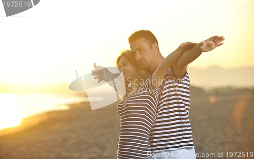 Image of happy young couple have romantic time on beach