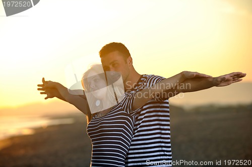 Image of happy young couple have fun on beach