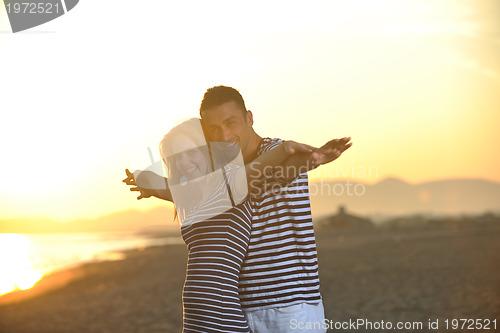 Image of happy young couple have fun on beach