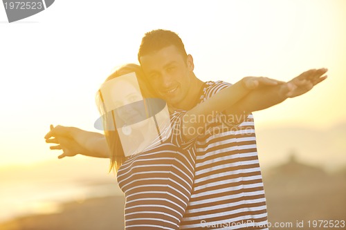 Image of happy young couple have romantic time on beach