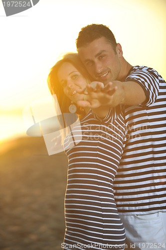 Image of happy young couple have romantic time on beach