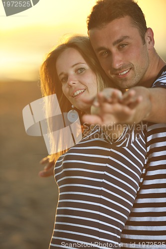 Image of happy young couple have romantic time on beach