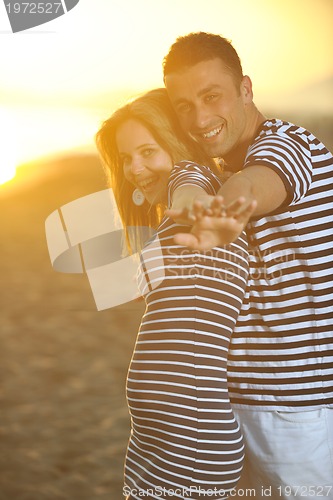Image of happy young couple have romantic time on beach