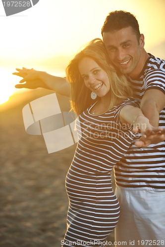 Image of happy young couple have romantic time on beach