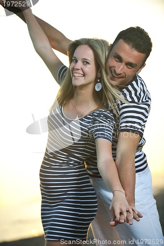 Image of happy young couple have romantic time on beach