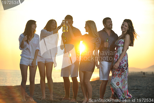 Image of Group of young people enjoy summer  party at the beach