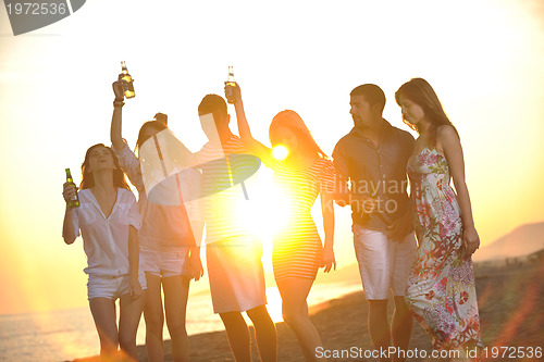 Image of Group of young people enjoy summer  party at the beach