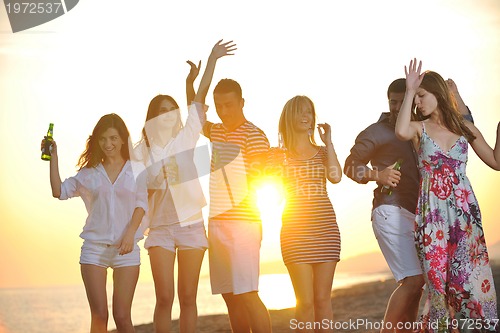 Image of Group of young people enjoy summer  party at the beach