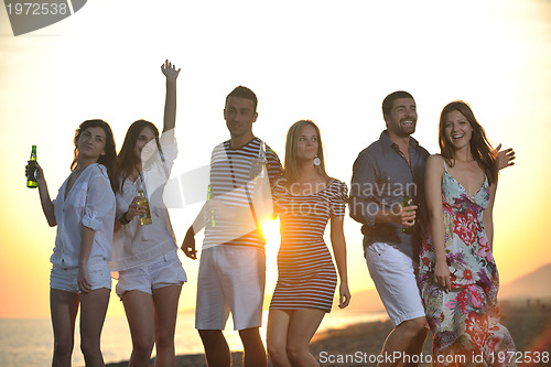 Image of Group of young people enjoy summer  party at the beach