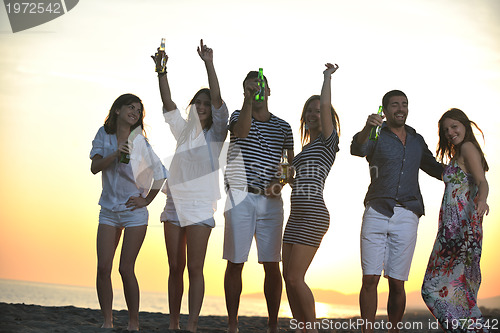 Image of Group of young people enjoy summer  party at the beach