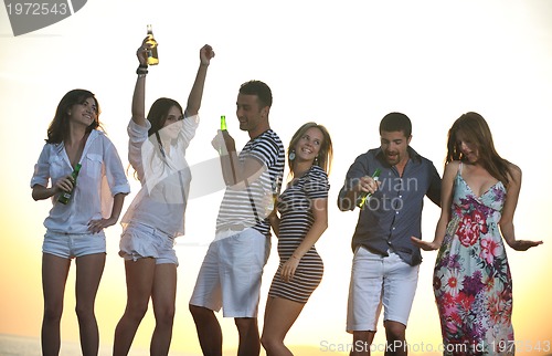 Image of Group of young people enjoy summer  party at the beach