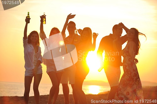 Image of Group of young people enjoy summer  party at the beach