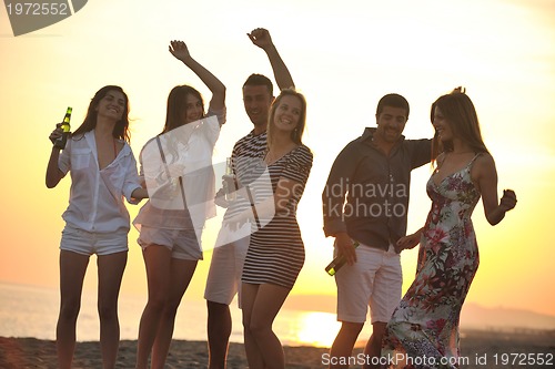 Image of Group of young people enjoy summer  party at the beach