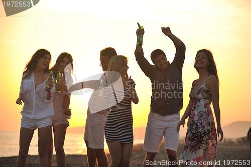 Image of Group of young people enjoy summer  party at the beach