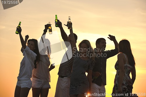Image of Group of young people enjoy summer  party at the beach