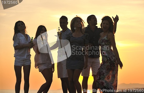 Image of Group of young people enjoy summer  party at the beach