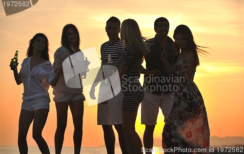 Image of Group of young people enjoy summer  party at the beach