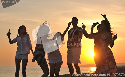 Image of Group of young people enjoy summer  party at the beach